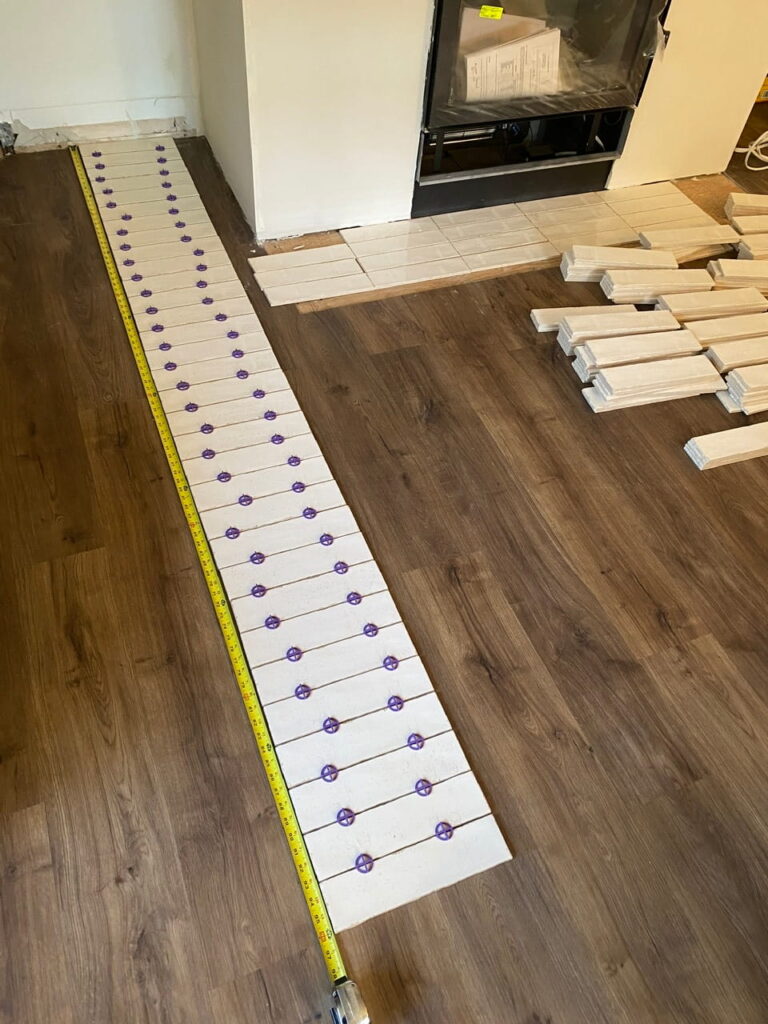 A column of subway tile laid out with spacers
